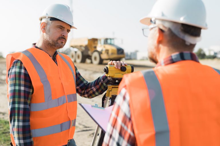 construction-workers-setting-equipment-in-the-midd-4MYE9MK-768x512